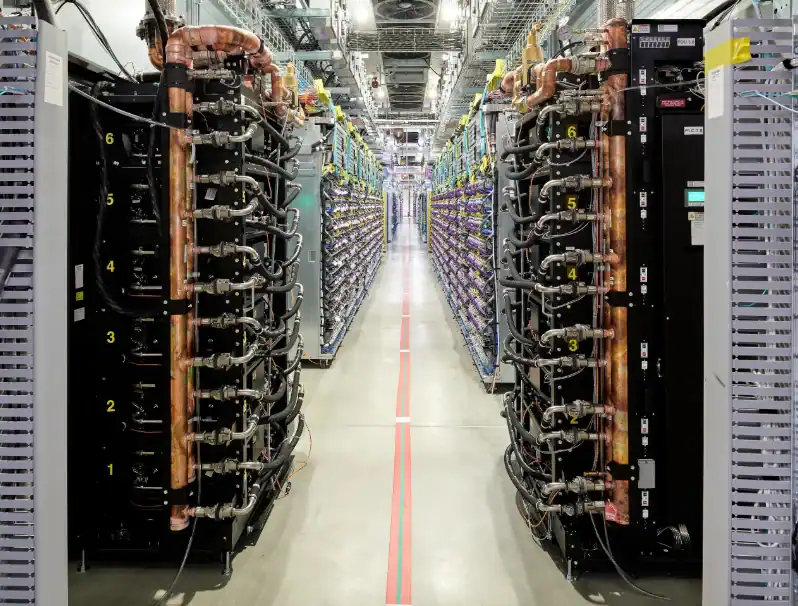 Copper liquid cooling pipes and coolant distribution units running along server racks inside a Google data center in New Albany Ohio